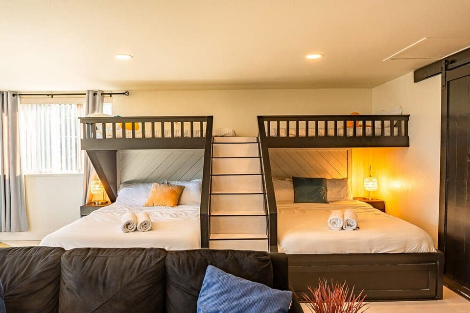Signature bunk room — 2 Queens, 2 Twin lofts & cozy sectional (sleeps 6)