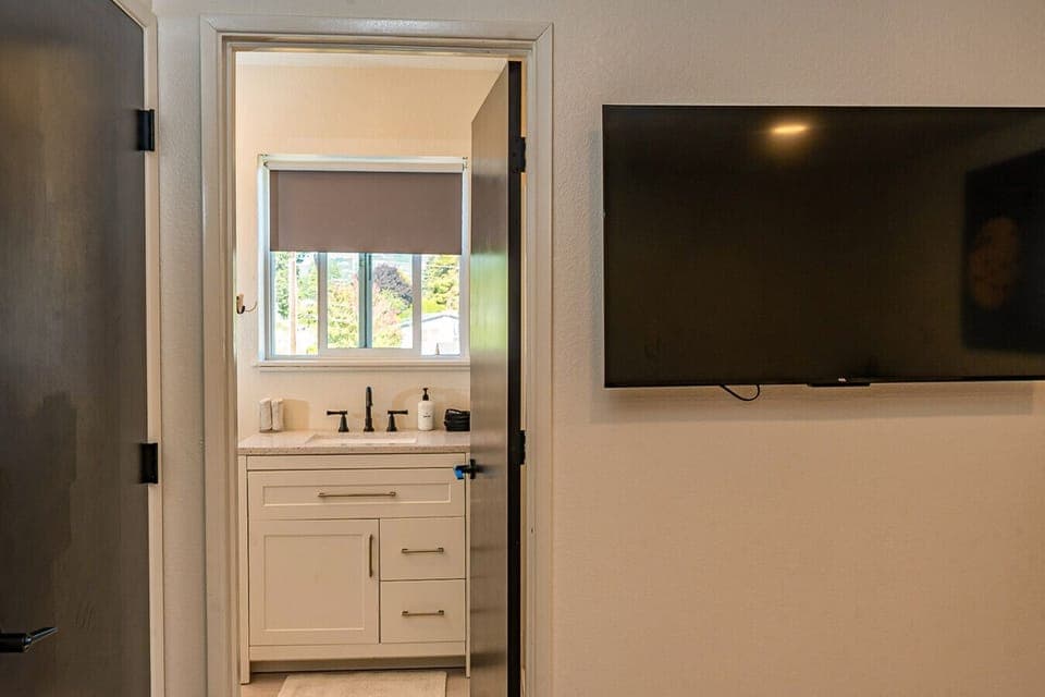The private wash room entrance leads to a clean, well-appointed bathroom space designed for guest convenience.