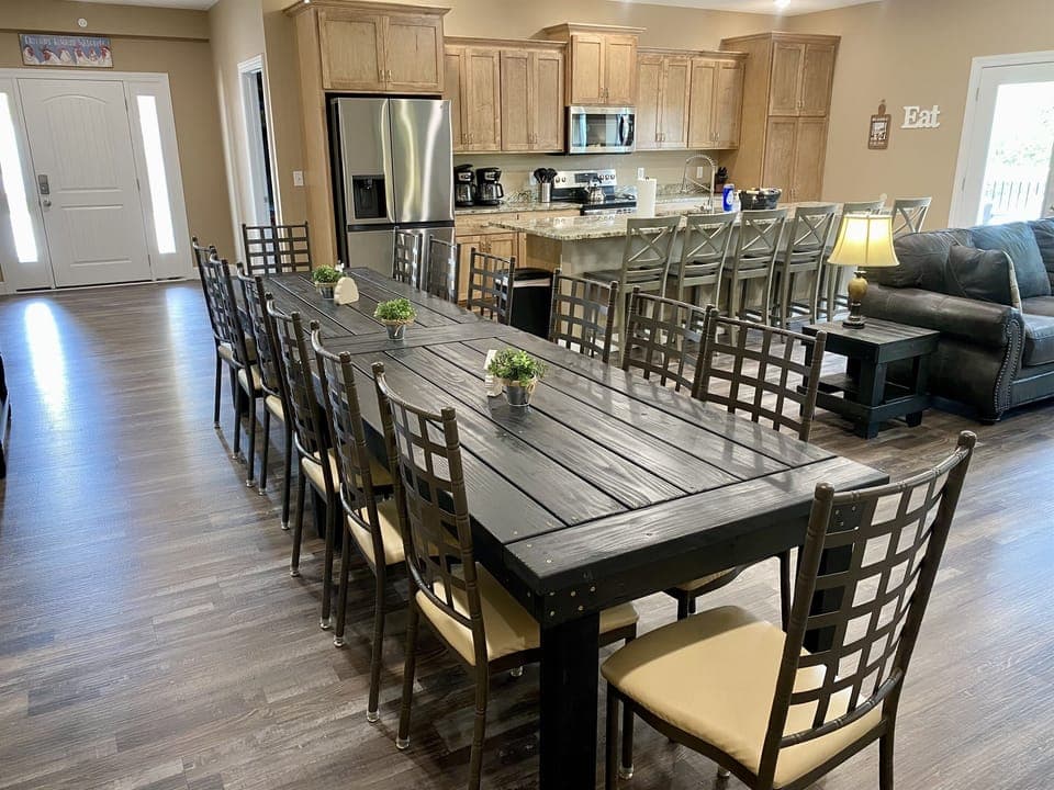 Seating for 14 around a custom built dining table.  Seating for 6 more at the kitchen island.