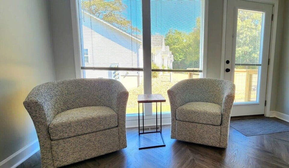 Sitting area in bedroom.  Rooms separated by sliding barn-door.