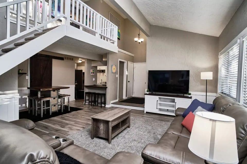 Living room with Smart TV and Leather couch with 4 reclining ends
