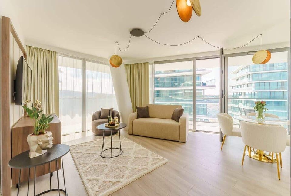 Relax in the stylish living room with a comfortable sofa and modern decor.