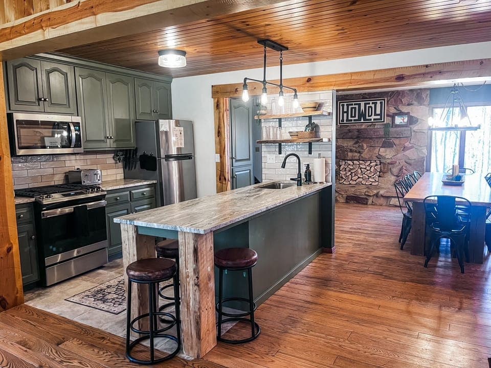 This freshly updated kitchen sits at the center of it all—open to a spacious dining room on one side and the cozy living room with a stone fireplace on the other. Whether you're cooking, gathering, or just snacking, there's room for everyone to be part of the moment.