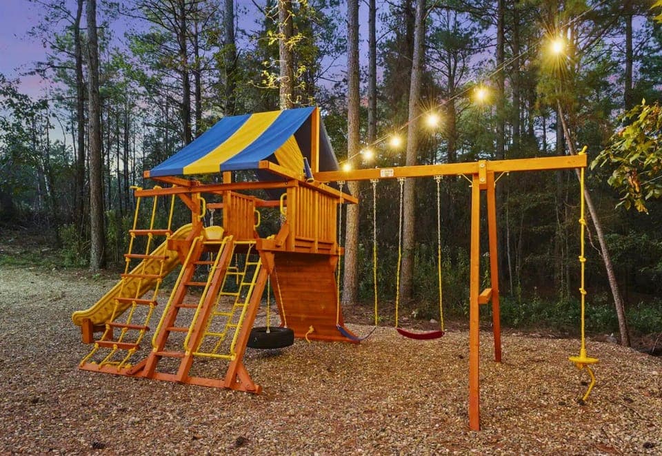 Adventure awaits the little ones in our vibrant backyard playground, a place for giggles and endless play under the fairy lights.