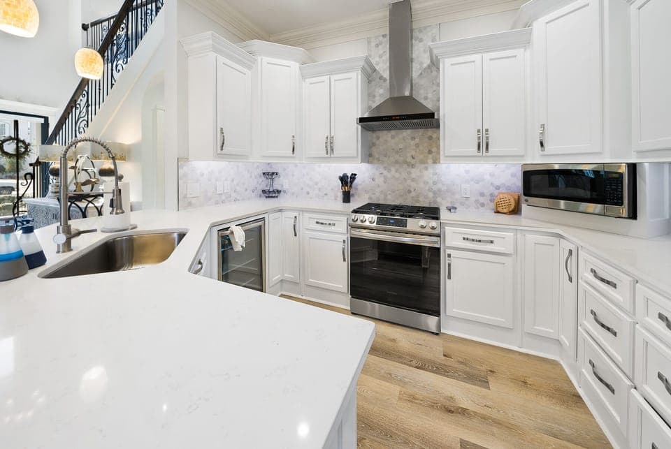 You'll love creating culinary masterpieces in this stunning chef's kitchen, featuring pristine white cabinetry, marble countertops, and premium stainless steel appliances.