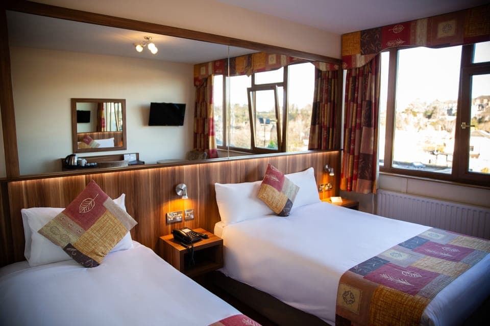 Standard Triple Room | Desk, laptop workspace, blackout drapes, iron/ironing board