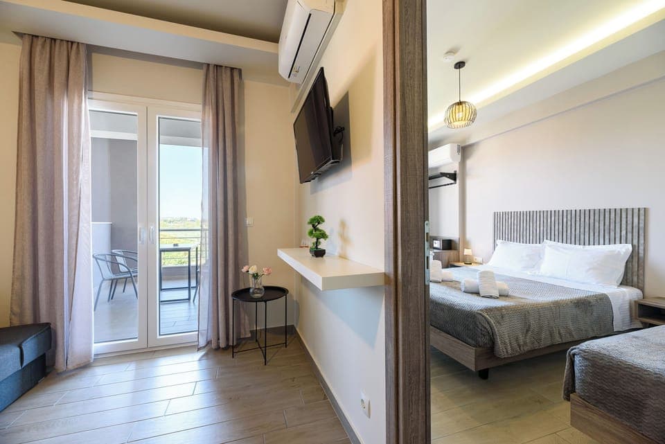 Family Apartment, Garden View | Living area | 43-inch Smart TV with satellite channels