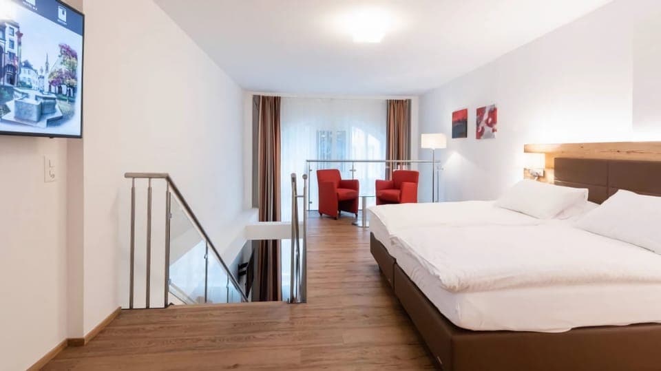 Executive Quadruple Room | Minibar, in-room safe, desk, blackout drapes