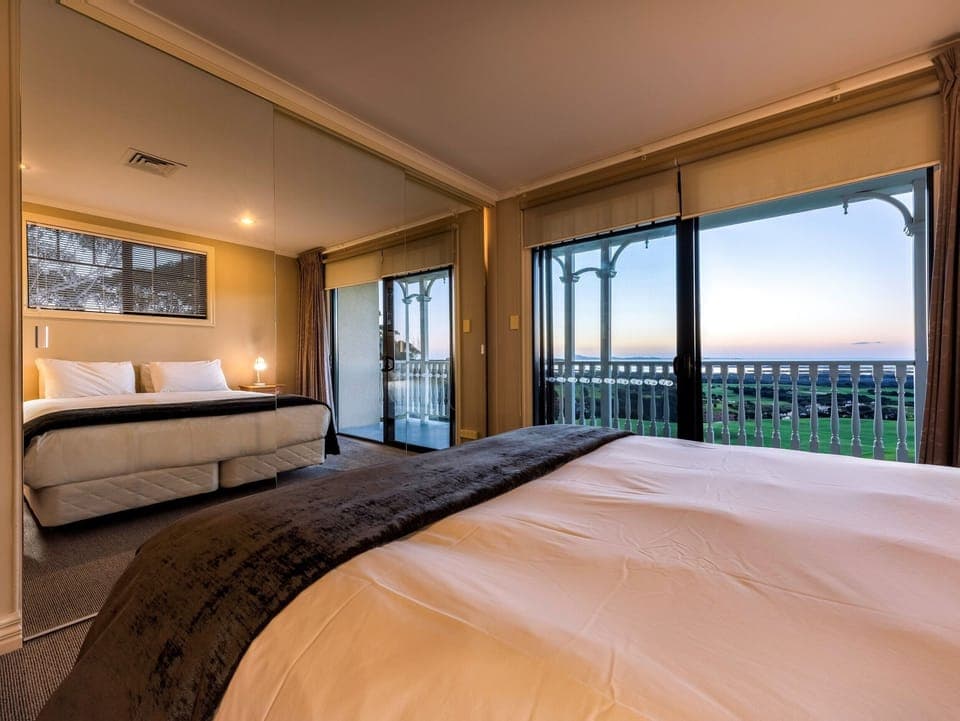 Premium bedding, desk, laptop workspace, blackout drapes