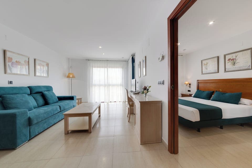Junior Suite, Balcony, Garden View | Living area | TV