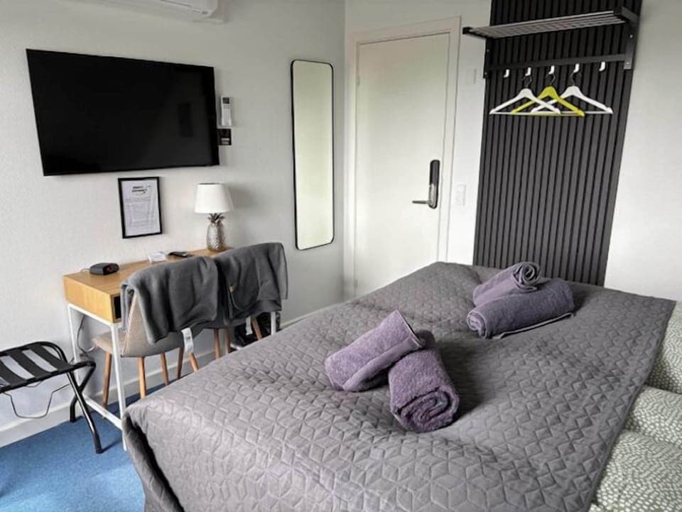 Desk, laptop workspace, blackout drapes, iron/ironing board