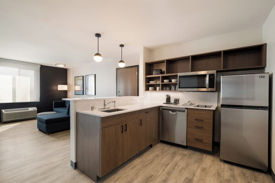 Suite, 1 King Bed, Non Smoking | Desk, laptop workspace, blackout drapes, iron/ironing board