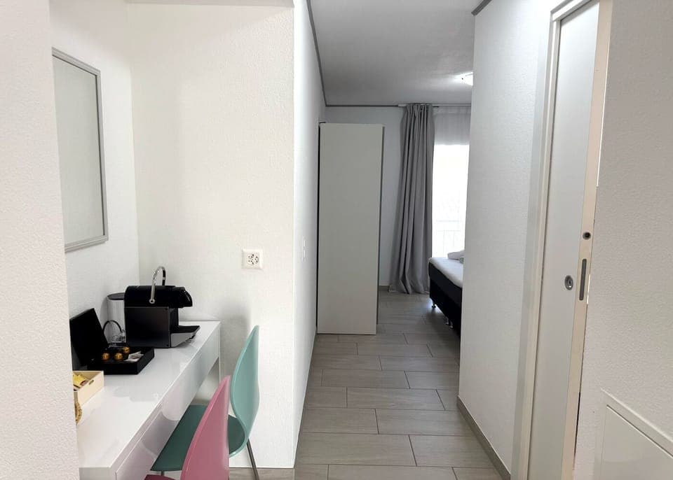 Family Triple Room, 1 Bedroom, Courtyard View | Living area | 100-cm TV with digital channels