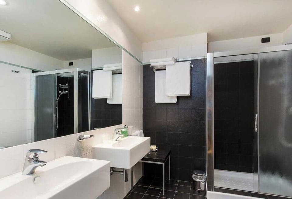 Suite, Lake View | Bathroom | Shower, hair dryer, slippers, towels