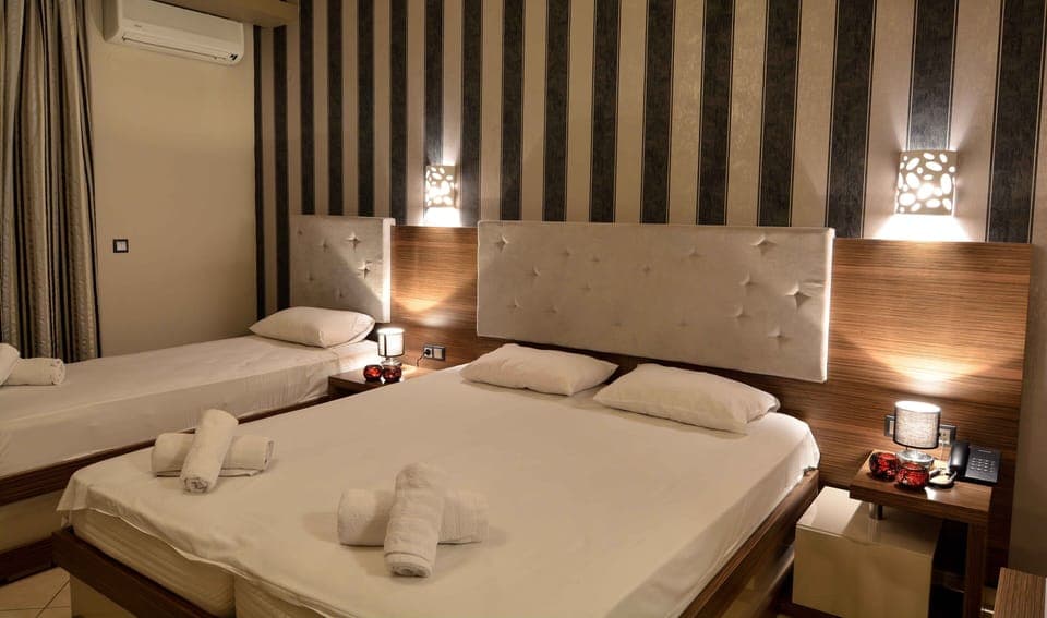 Deluxe Triple Room, Partial Sea View | Premium bedding, minibar, in-room safe, blackout drapes