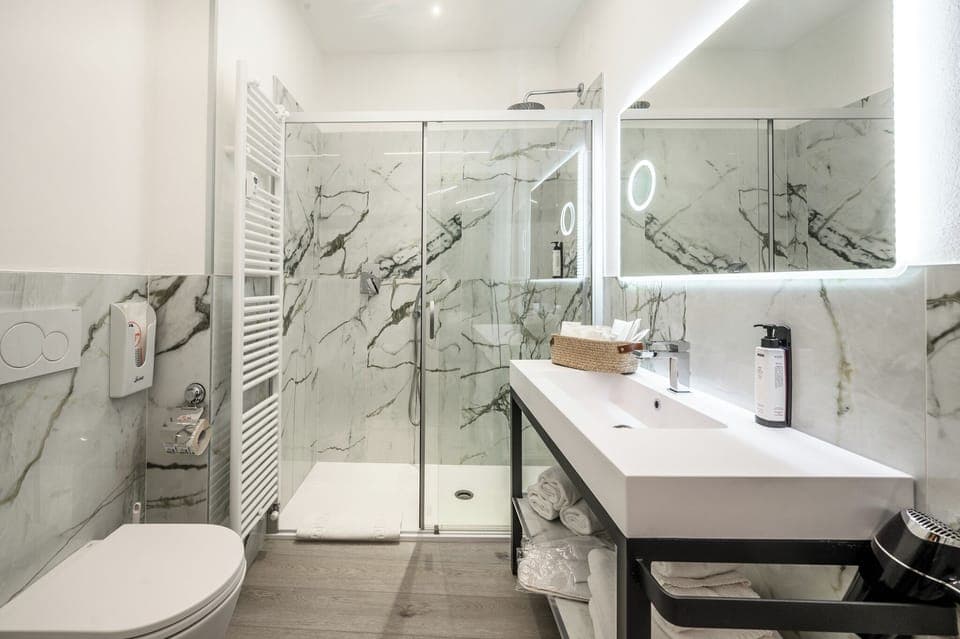 Family Triple Room, Balcony, Courtyard View | Bathroom | Shower, rainfall showerhead, free toiletries, hair dryer