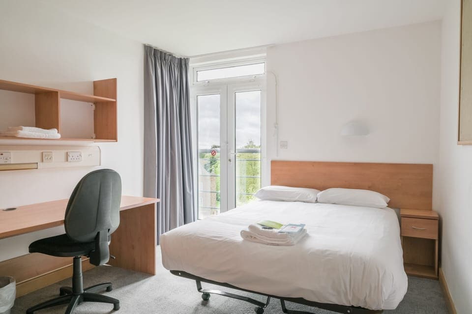 Desk, laptop workspace, blackout drapes, iron/ironing board