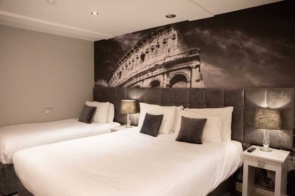 Hypo-allergenic bedding, desk, laptop workspace, blackout drapes