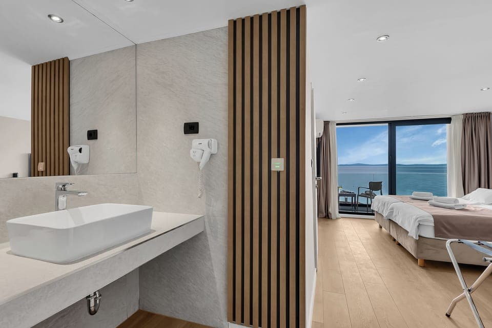 Double Room With Sea/Pool View | In-room safe, desk, blackout drapes, bed sheets