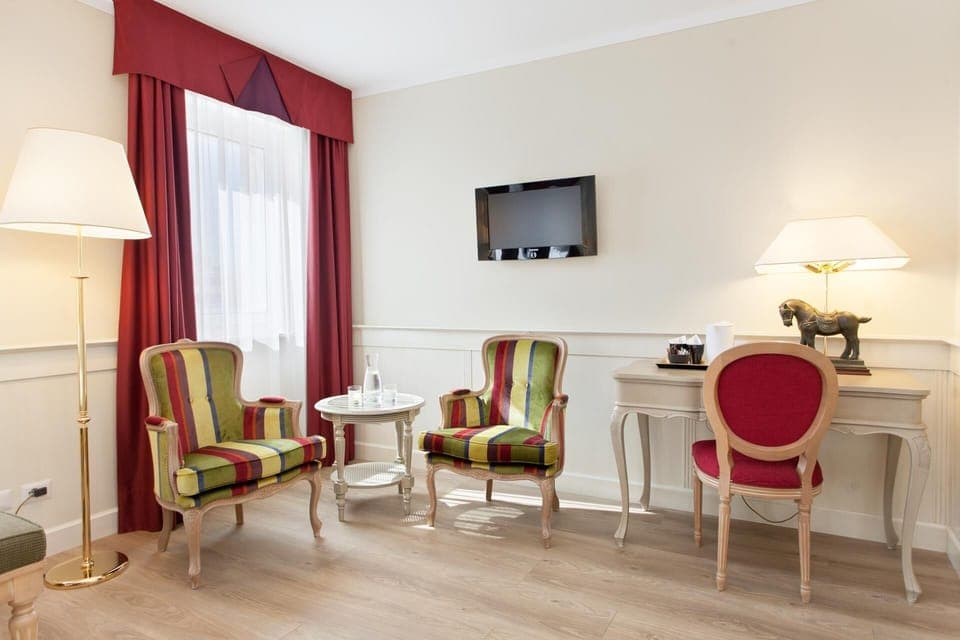 Junior Suite | Living area | 26-inch flat-screen TV with digital channels, TV