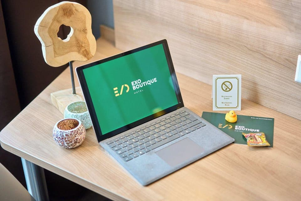 Hypo-allergenic bedding, desk, laptop workspace, blackout drapes