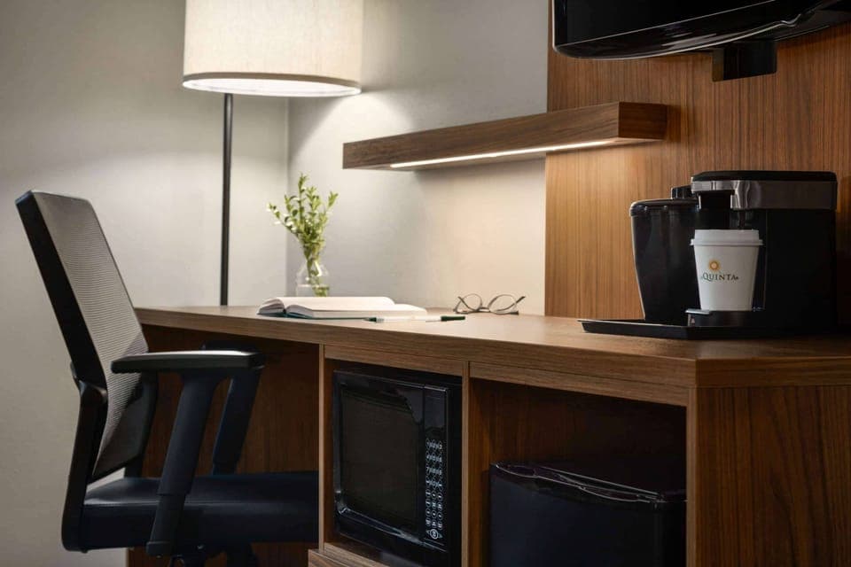 Premium bedding, desk, laptop workspace, blackout drapes