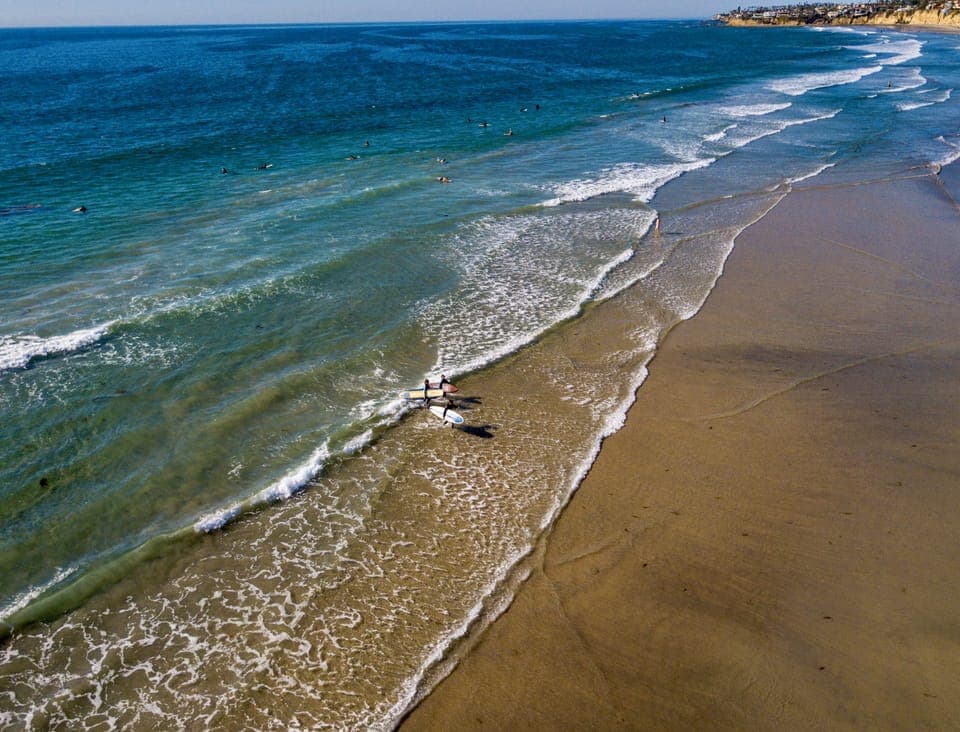 Beach nearby, white sand, beach umbrellas, beach towels