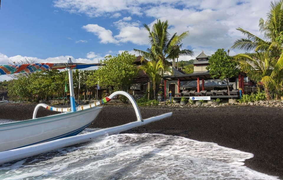 On the beach, black sand, sun loungers, beach towels