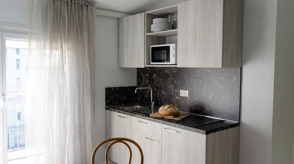 Full-size fridge, microwave, stovetop, coffee grinder