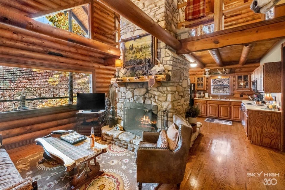 Luxury Cabin, Multiple Beds, Jetted Tub, Lake View (The Cattleman) | Living area | 50-inch Smart TV with satellite channels, fireplace, DVD player
