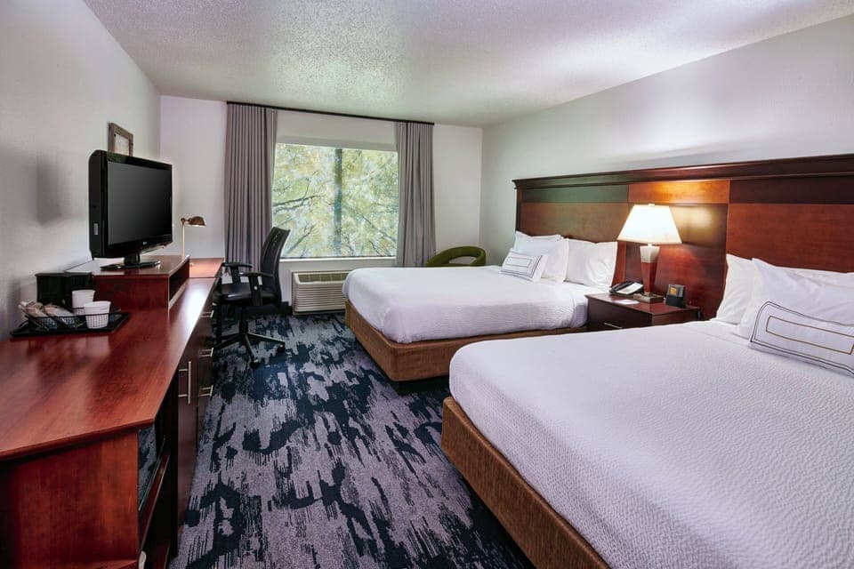 Premium bedding, desk, laptop workspace, blackout drapes