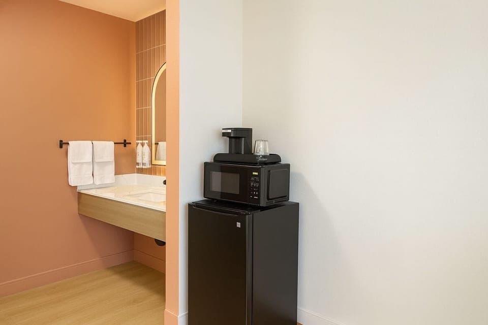 Premium bedding, desk, laptop workspace, blackout drapes