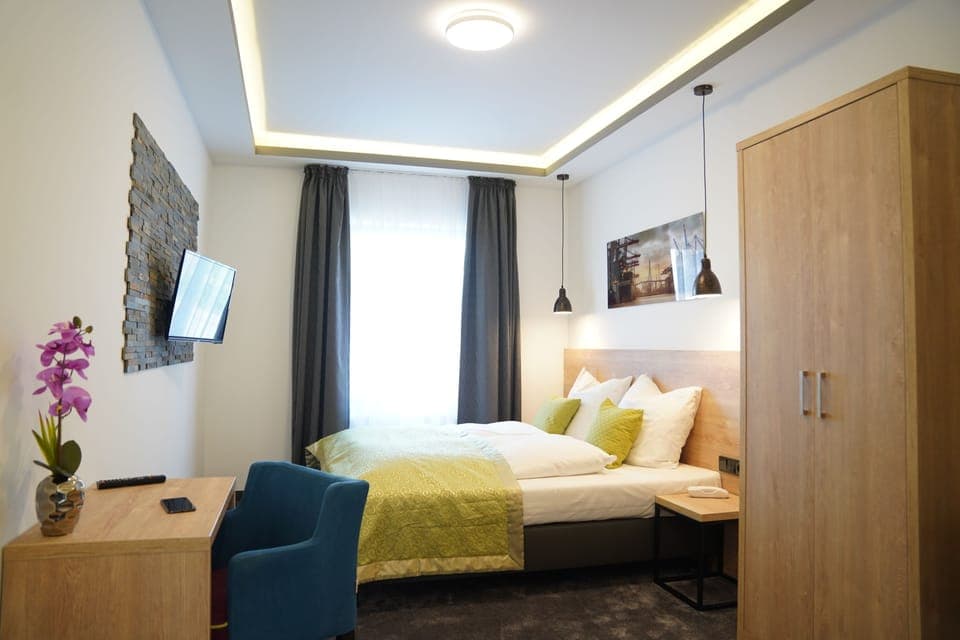 Double or Twin Room | Down comforters, desk, laptop workspace, blackout drapes