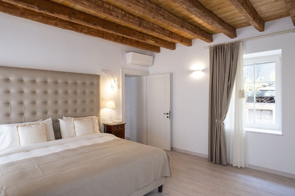 Deluxe Suite, Partial Lake View | 1 bedroom, hypo-allergenic bedding, down comforters, minibar