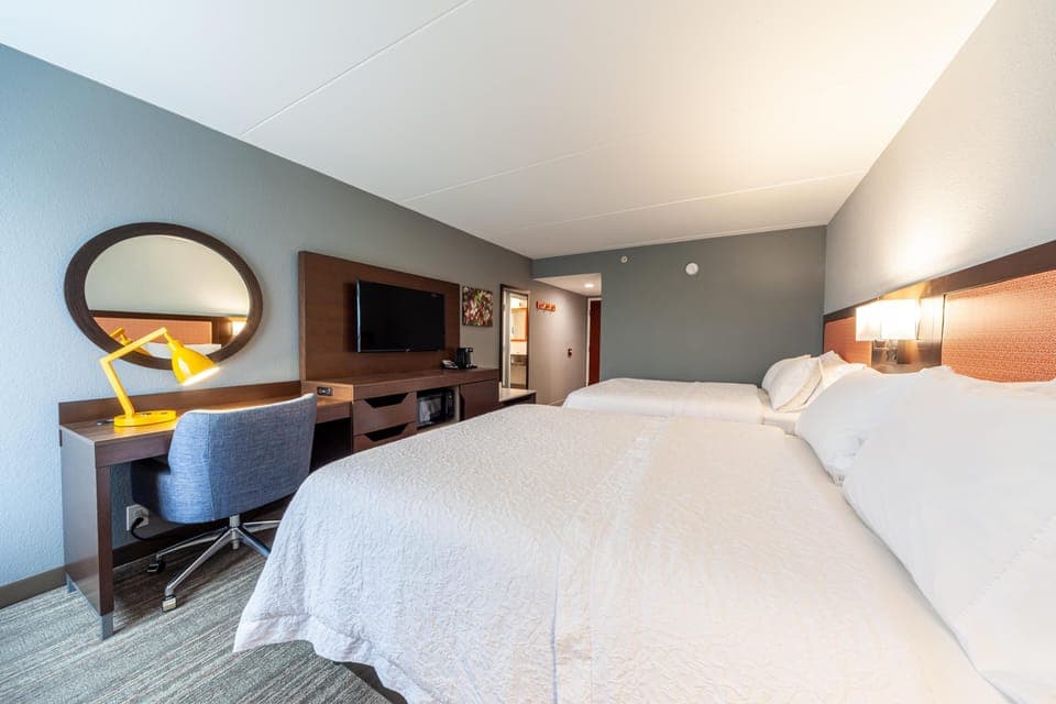 Room, 2 Queen Beds, Non Smoking | Living area | 32-inch LCD TV with satellite channels, TV, MP3 dock