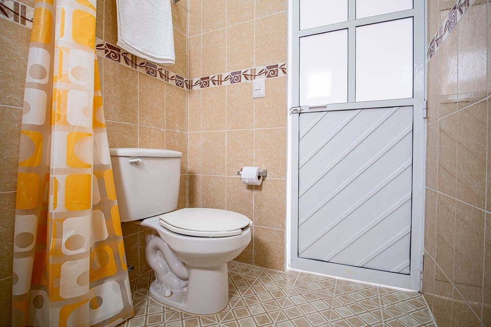 Standard Room (Three beds) | Bathroom | Shower, towels, soap, shampoo