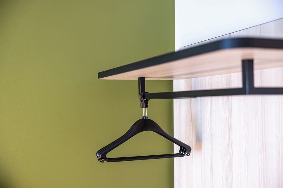 Hypo-allergenic bedding, desk, laptop workspace, blackout drapes