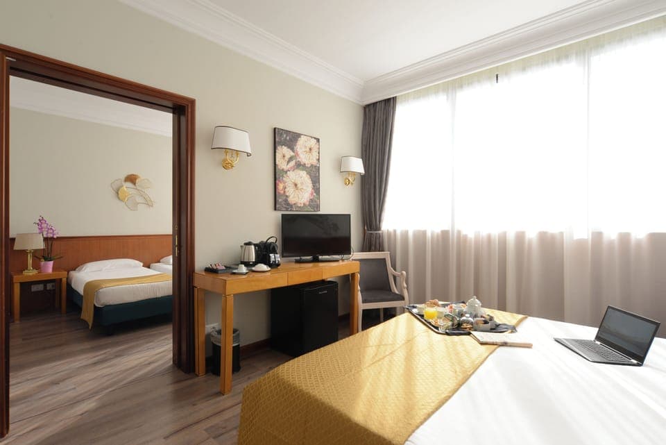 Family Room | Premium bedding, in-room safe, desk, iron/ironing board