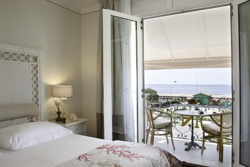 Classic Double Room, Balcony, Sea View | Minibar, in-room safe, desk, blackout drapes