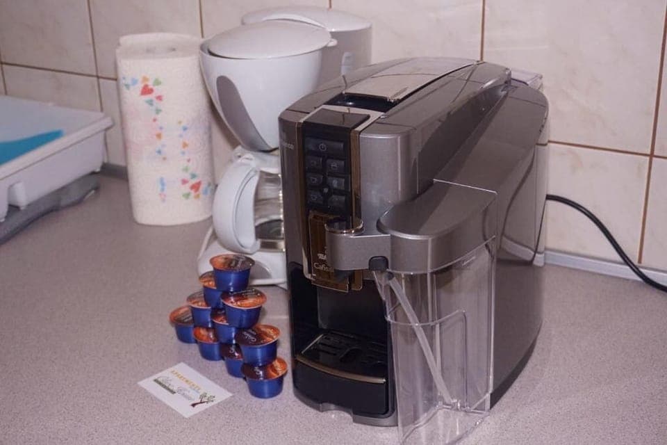 Full-size fridge, stovetop, cookware/dishes/utensils, cleaning supplies