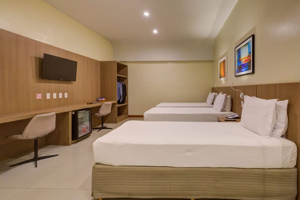 Deluxe Triple Room | Minibar, in-room safe, desk, soundproofing