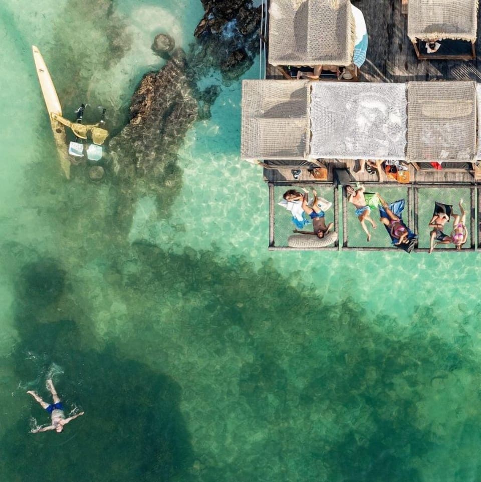 On the beach, white sand, sun loungers, beach umbrellas
