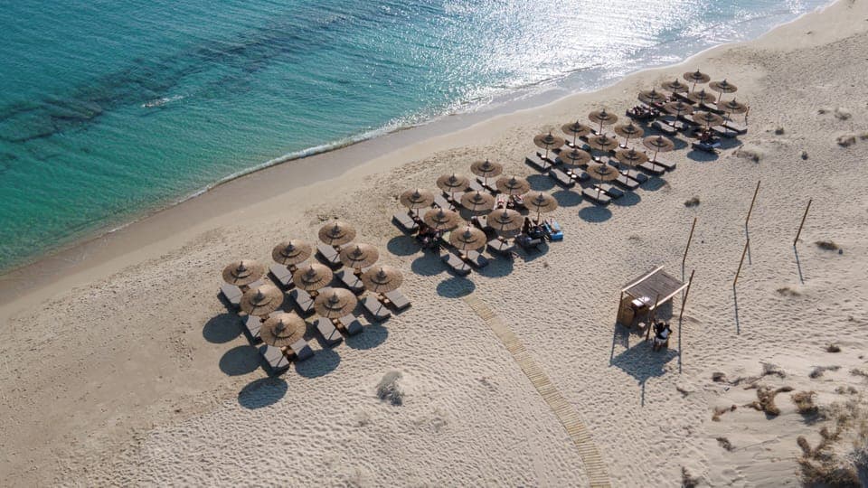 On the beach, white sand, sun loungers, beach umbrellas