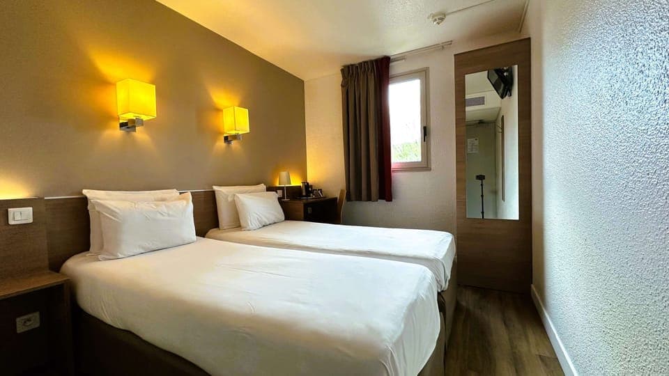 Premium bedding, desk, laptop workspace, blackout drapes