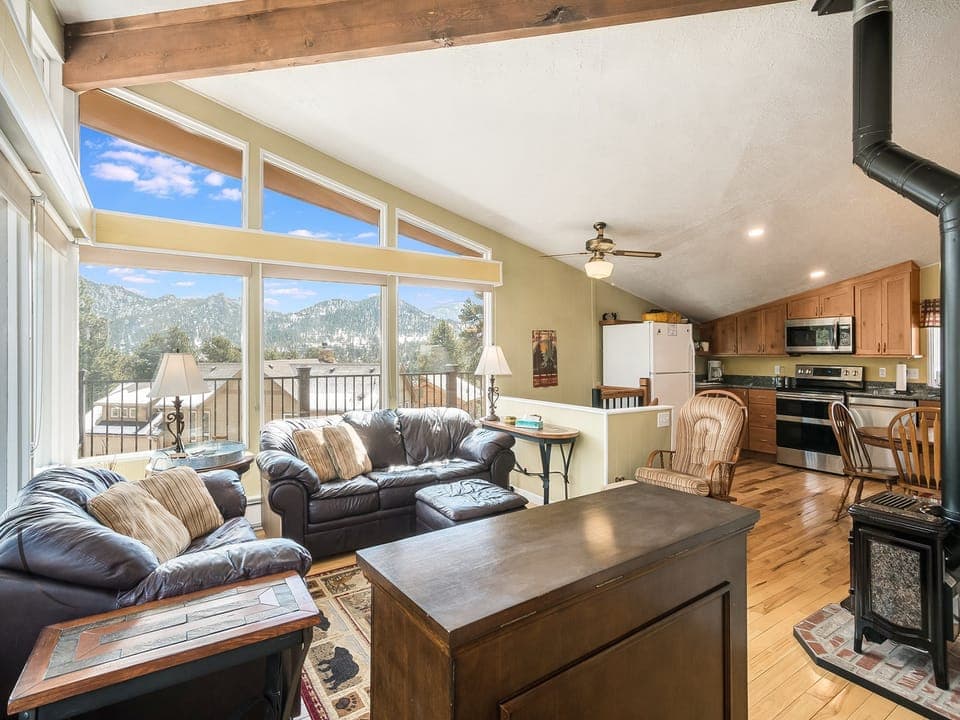 Starlight in the Rockies - Living room with a couch, loveseat, ottoman and fireplace