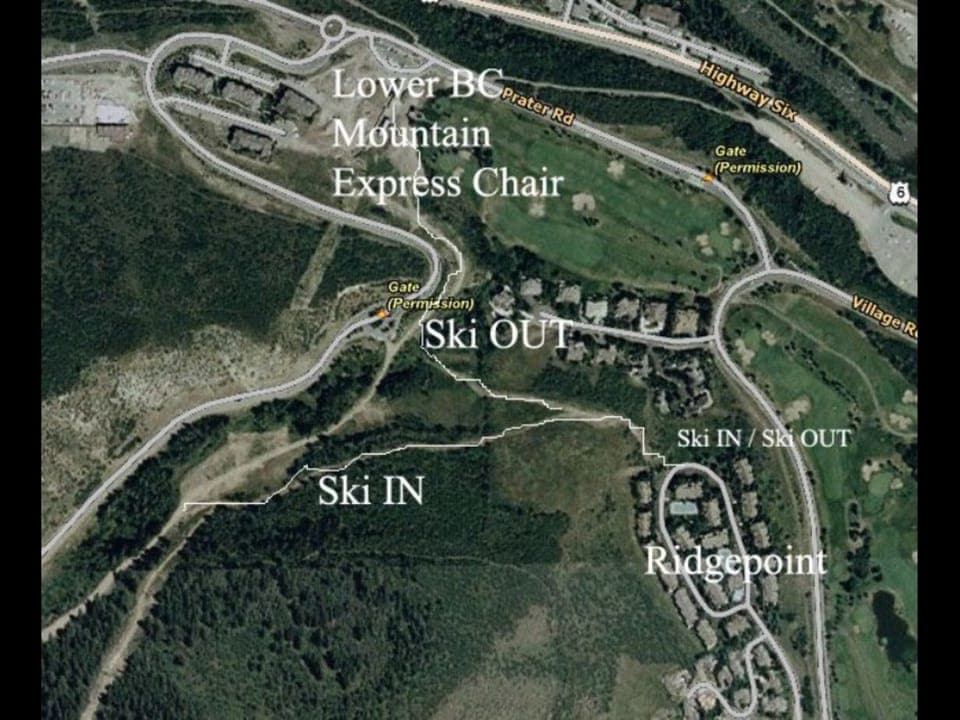 Aerial view of a ski resort area with labeled routes. "Lower BC Mountain Express Chair" at top. "Ski OUT" and "Ski IN" paths marked, connecting to local roads and "Ridgepoint" residential area.