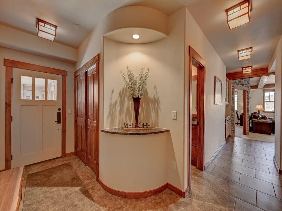 A hallway entrance with beautifully tiled floors and modern decor welcomes you