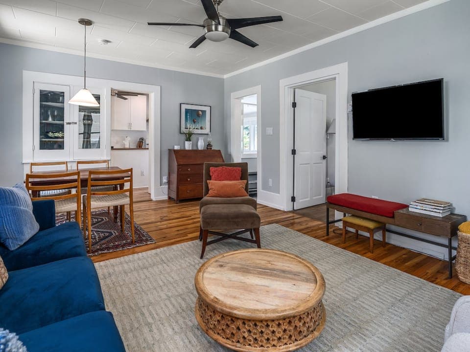 Upon entering, you will immediately find the living area. - Brown chair, blue couch, kitchen table