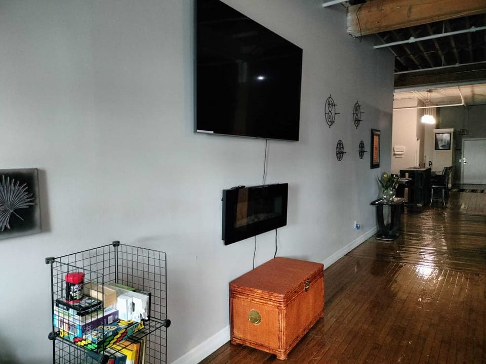 Overly spacious living room, tru-heat LED touchscreen fireplace, 75' Smart TV, throw-blanket chess w/lightweight workout equipment, weights, yoga mats, Variety of board games, books and educational entertainment for children and adults.