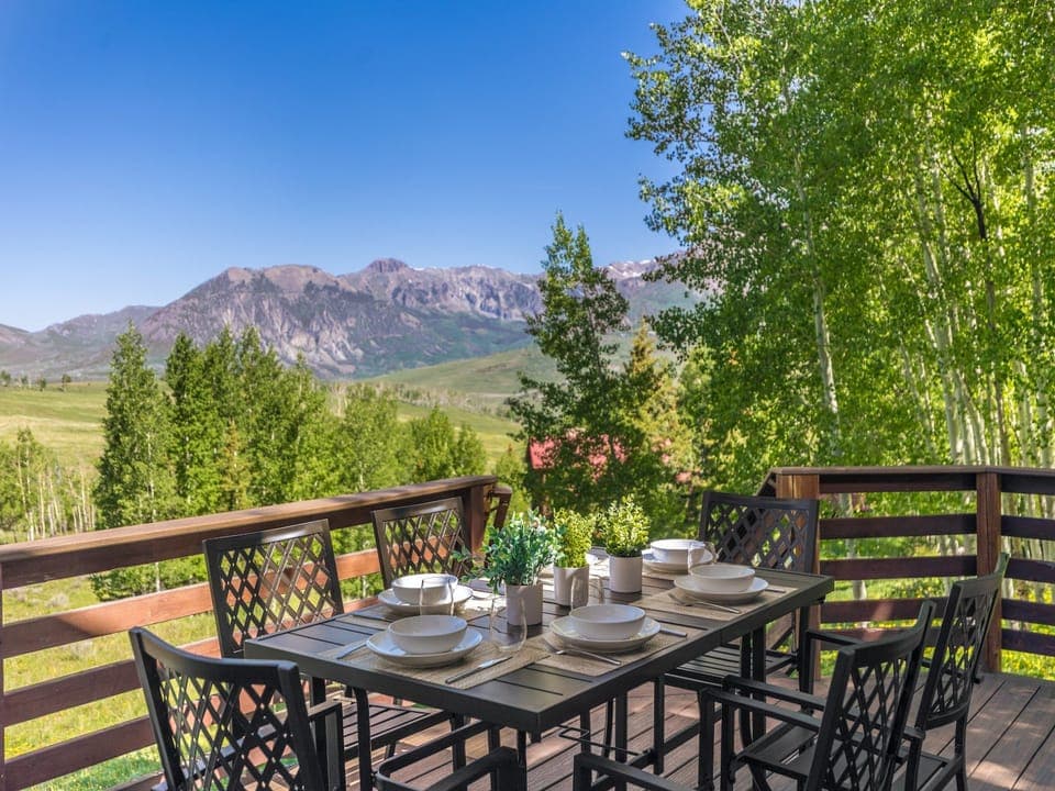 This home features stunning views with a multi-level deck featuring outdoor seating/dining, hot tub, gas grill and a huge open backyard.